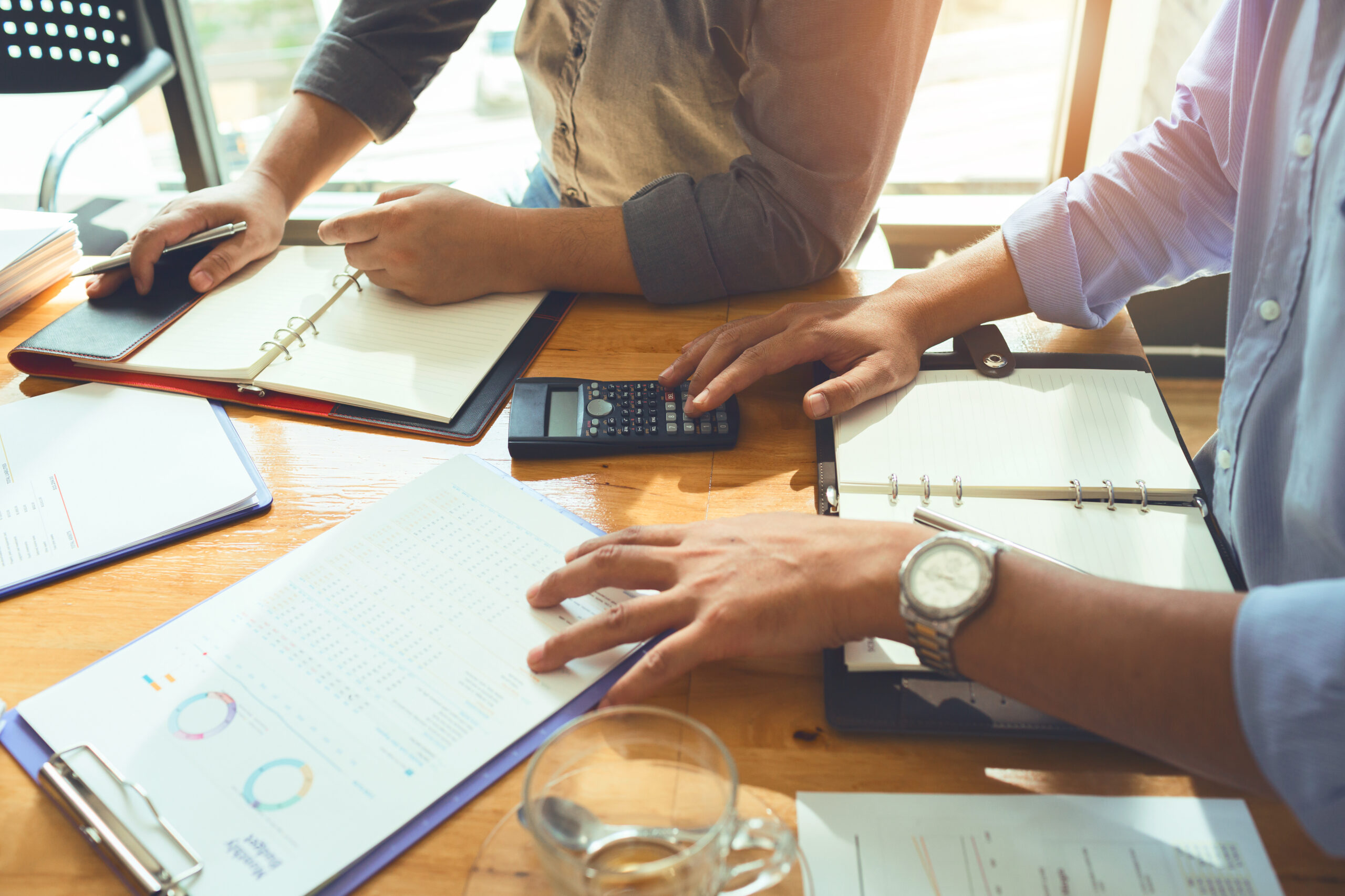 Team of business associates monthly meeting to plan a loan to buy real estate. And movable property to calculate and budget appropriately and save the most money.